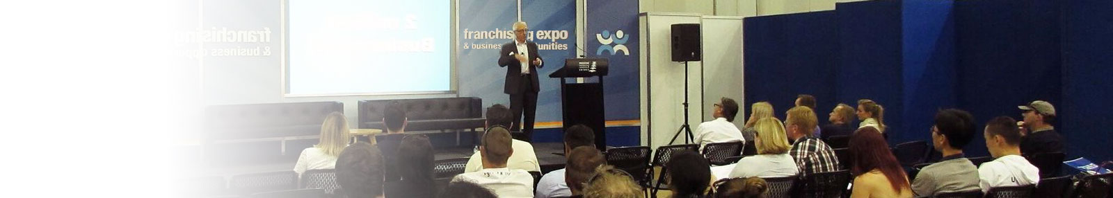 Brian Keen on stage presenting at the expo