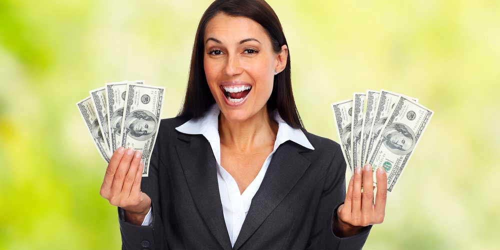 happy woman holding dollar bills