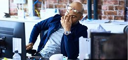 stressed man while working on a computer