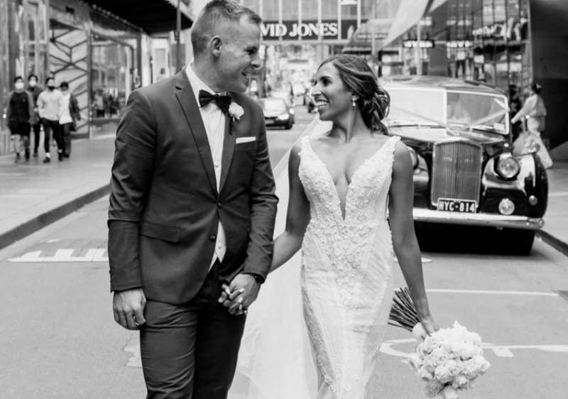 Newlywed man and woman in grayscale on the street