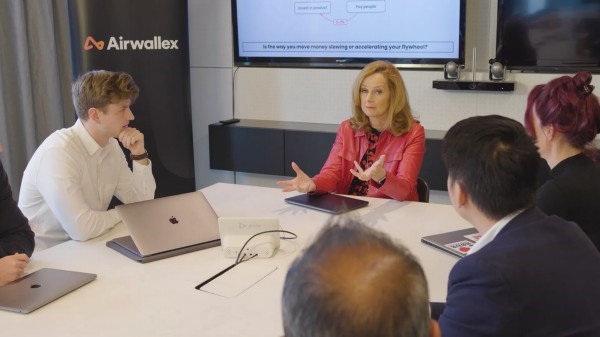 Image of a CEO leading a meeting with employees, symbolizing leadership and collaboration in the workplace.