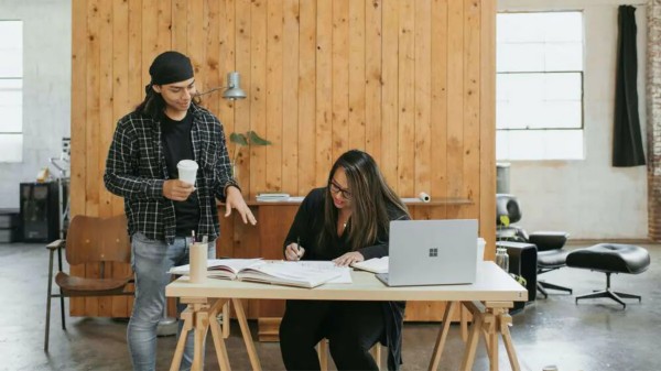 Image of a male and a female working together in an office setting.