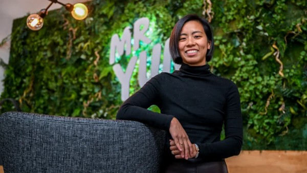 Smiling woman wearing a black turtleneck long-sleeve shirt