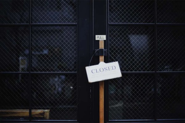A door with a 'Closed' sign