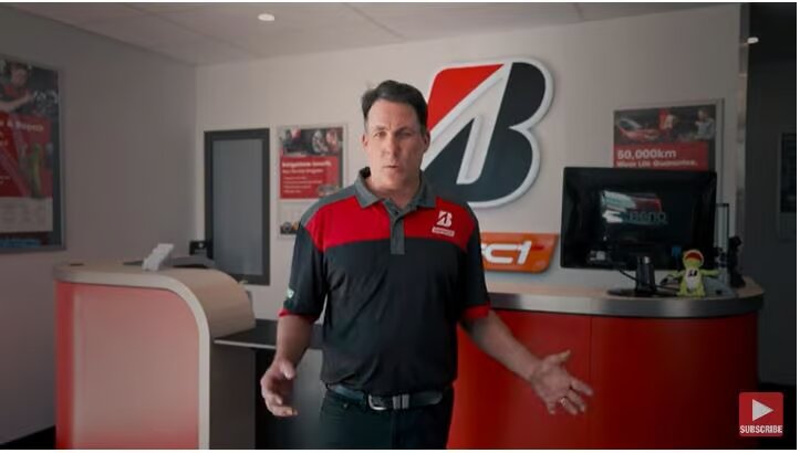 A man in a 'Bridgestone' uniform engaged in a discussion