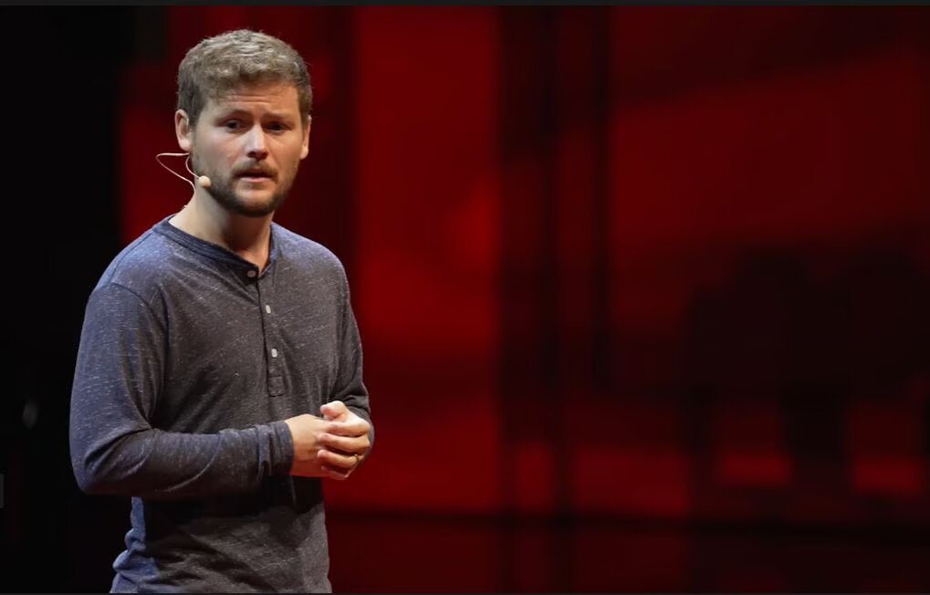 Drew Lynch speaking on stage
